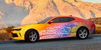 Colorful race car in the rockies, covered in 3M™ Scotchlite™ Print Wrap Film 780mC-10R

