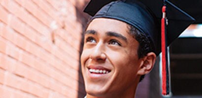 teen boy with clear braces and clear rubber bands smiling at graduation