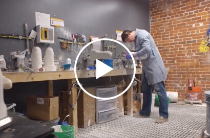 Worker at a bench forming a prosthetic limb