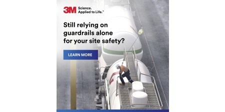 Front cover of a brochure showing a worker climbing on top of a tanker truck on a road.
