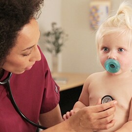 Pediatric nurse listening to the chest of a toddler with a 3M Littmann Classic III Stethoscope. 