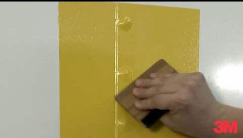 3M expert graphics installer applying a car wrap over rivets on a car, showing ease of install over rivets.
