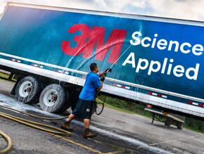 man washing the outside of a truck wrapped in 3m graphic film 