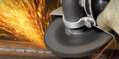 Grinding application using a 3M Silver Depressed Center Grinding Wheel with sparks flying
