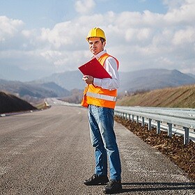 An engineer wearing a helmet at the highway road. 