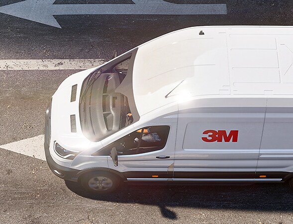 White cargo van with 3M cooling film on the rooftop.
