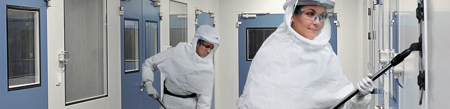 worker wearing a papr hood cleaning a room
