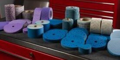Rolls of blue tape on a counter
