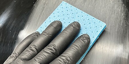 Image of a gloved hand with foam sheet
