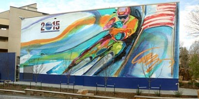 A big billboard with a graphic of a colorful painted downhill skier wrapped with 3M Envision luster wrap overlaminate 8549L.
