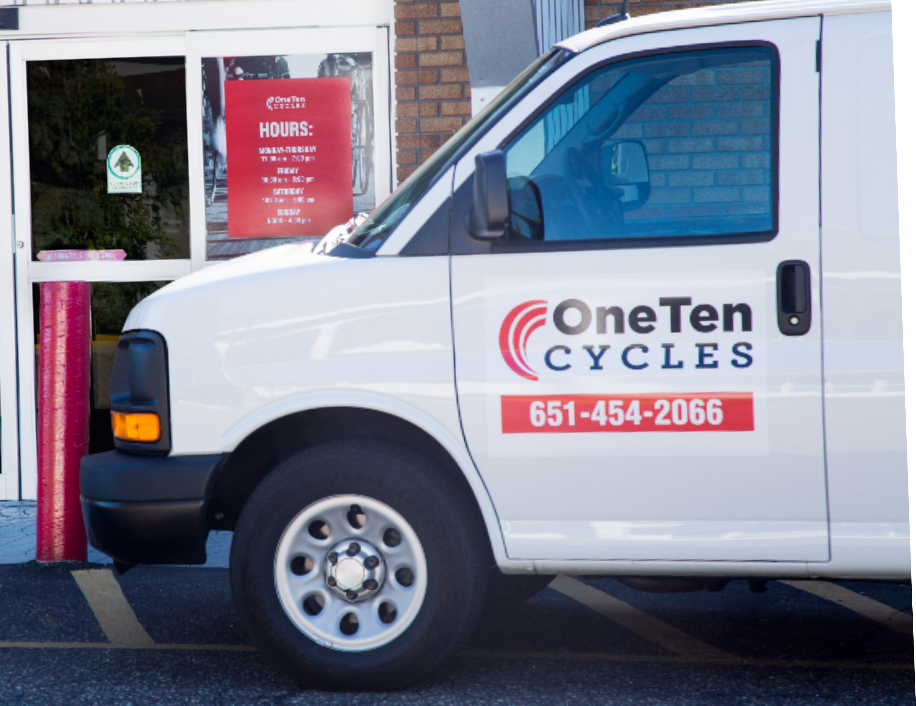 White delivery van with 3M spot graphics for OneTen Cycles.
