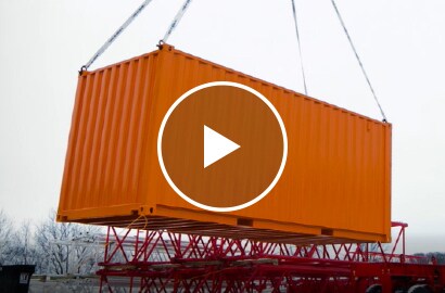 Video still of a shipping container weighing over seven tons being held aloft.