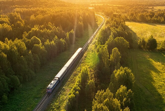 Train travelling through a forest with passive train cooling technology
