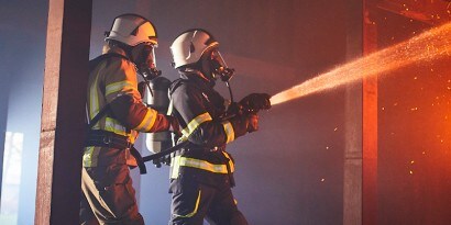 firefighter entering a building wearing a Vision C5 facepiece
