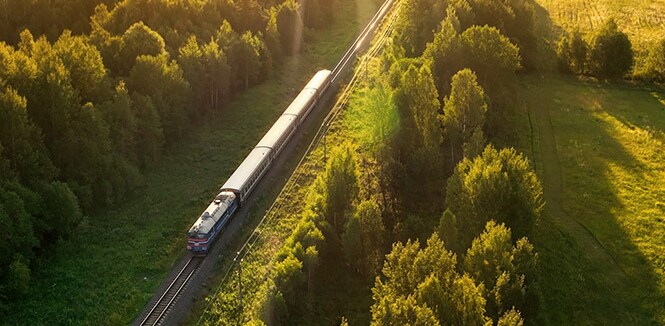 Train travelling through a forest with passive train cooling technology
