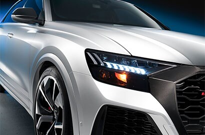 White SUV front close-up with headlights
