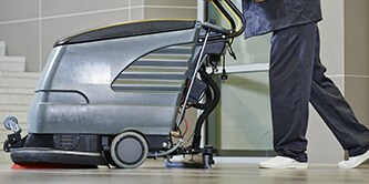 Employee using a floor cleaning machine

