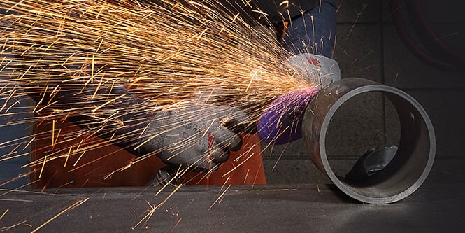 person using a tool on a cylinder object
