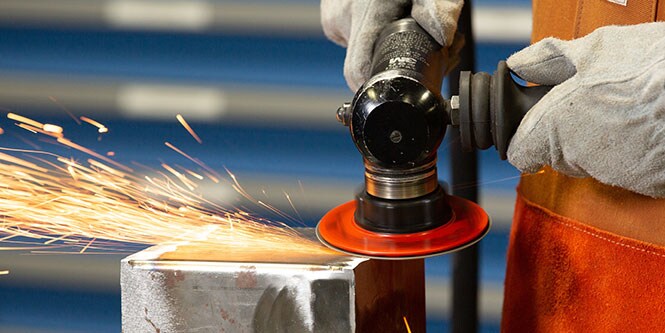 person removing a weld
