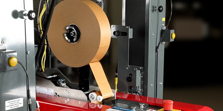 Paper box sealing tape in an automated sealer.
