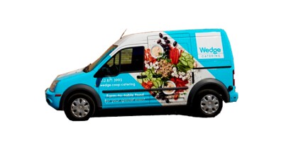 Delivery van with blue fleet wrap that has images of food on the side.
