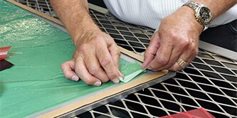 A man is applying green colored composite bonding
