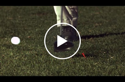 Video still showing a golf ball after being struck by the head of a golf club
