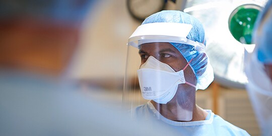 surgeon with personal protective equipment to prevent surgical site infection

