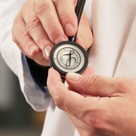 Close up of a doctor holding the chestpiece of a 3M Littmann Stethoscope with the Littmann seal on the diaphragm.